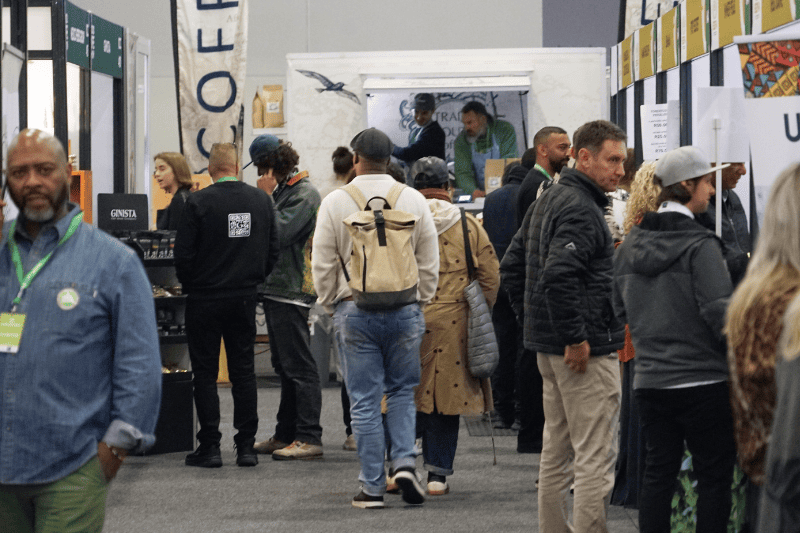 A busy trade exhibition hall filled with international buyers browsing food and wellness stalls at The Good Life Show Africa expo.