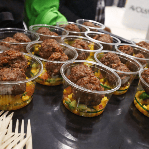 Trays of free plant-based food samples and giveaways for visitors to taste at The Good Life Show marketplace.